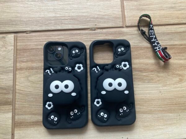 2 Cartoon Black 3D Silicone iPhone 13 Pro Cases with a Kenya bracelet behind the scenes