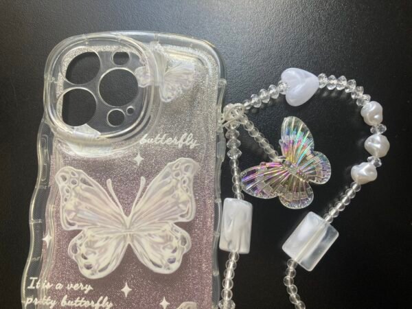 Pink Glitter TPU Butterfly Case with Strap Chain on a black table