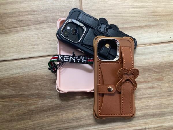 Pink, brown, and black Leather Wristband strap for iPhone 13 Pro on wooden floor