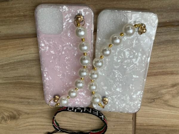 2 Marble iPhone Cases With Bead Pearl Wrist Strap on Wooden Floor with a Kenyan Bracelet